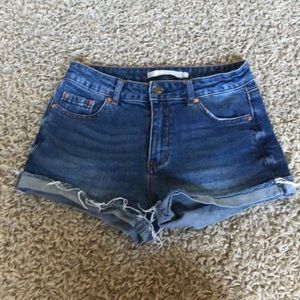 cuffed and frayed blue jean shorts